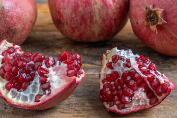 Fresh pomegranate fruit for Jewish holiday Rosh Hashanah on wooden background.