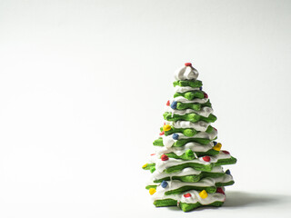 Green cookie christmas tree made by star cookie cutter on white background. New Year Christmas card. Matcha Green Tea Gingerbread Christmas tree Cookies covered with white chocolate. Copy space.