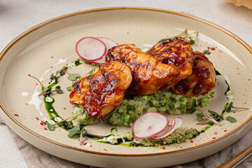 Portion of grilled chicken breast with risotto