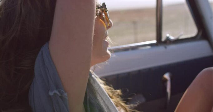 Travel, road trip and freedom woman with sunglasses for summer by countryside vacation, holiday and adventure in nature. Natural, sunshine and care of young girl driving or drive in boho lifestyle
