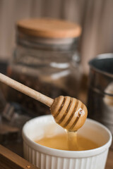 Photo of honey dripping from a wooden spoon