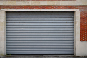 Fototapeta na wymiar old metal roller door large grey garage house gray and industrial silver warehouse