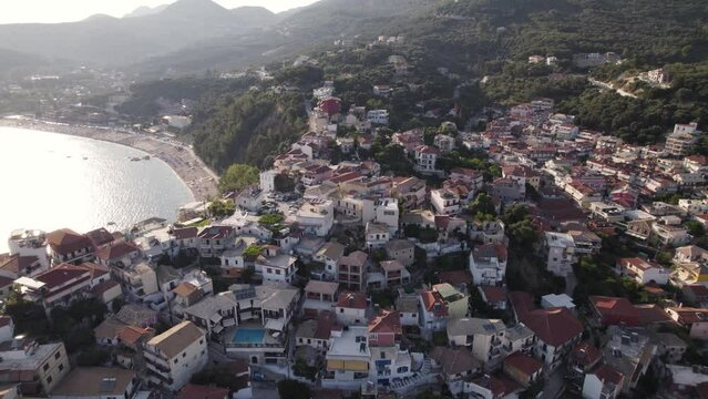 Aerial over scenic seaside resort town Parga - view of touristic Valtos beach 