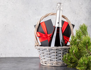 Basket with Christmas gift boxes, champagne
