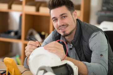 young electrician testing appliance electrical signal