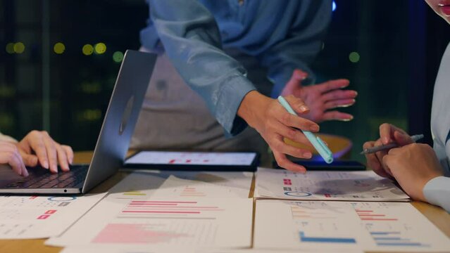 Close-up asia business people meeting plan analysis statistics brainstorm and header of team hold tablet pointing graph chart and employee take note. Finance strategy statistics success concept.