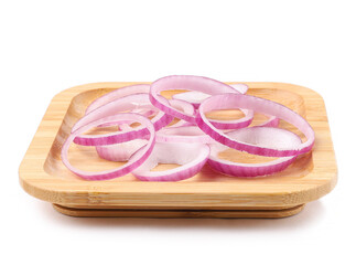 Raw purple onion on a square wooden plate, rings, white background