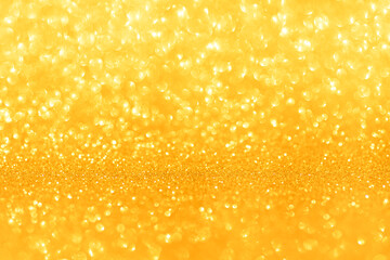 Golden glittering background for design and free space.