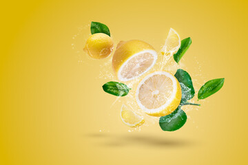 Water Splashing and yellow lemon fruit on a yellow background - obrazy, fototapety, plakaty