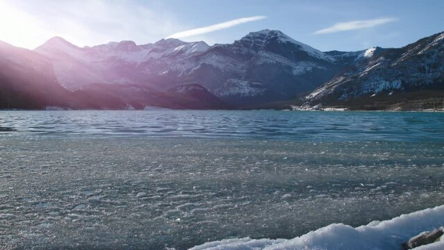 Winter icy Barrier Lake with Rocky Mountains on background