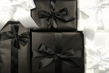 Gift white and black box with bow and envelope. White background. Holiday concept. Christmas. New Year. Valentine's Day.