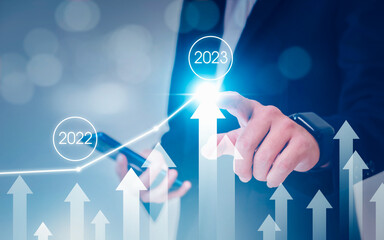 Businessman pointing arrow graph . Business development to success analysing data to increase sales...
