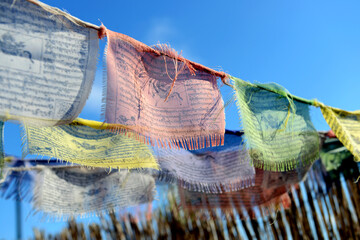 Tibetan flags moving with the wind, spreading prayers and good intentions - obrazy, fototapety, plakaty