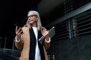 Caucasian adult business woman leaving office with laptop