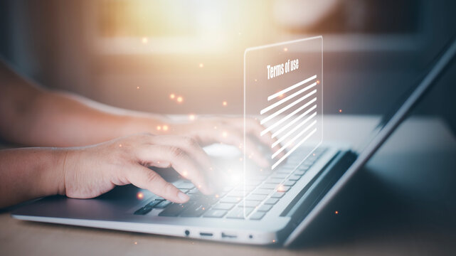 Man using a laptop with a graph of Terms of use concept, online banking check budget planning concept banner for website header design,Terms of use business concept. Terms and conditions of contract.