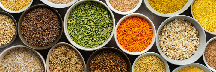 Various grain cereals in bowls banner, top view