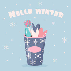 Plastic cup of coffee with snowflakes ornament, lollipop and sweet hearts. Hello winter quote. Greeting card.
