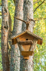 Wooden birdhouse on a tree in the spring forest