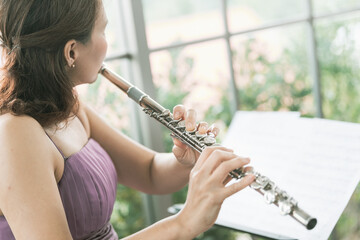 Flute :  A closeup of hands of a musician playing the flute, detail shot, classical music, wind instrument performance player up close abstract.. © fototrips