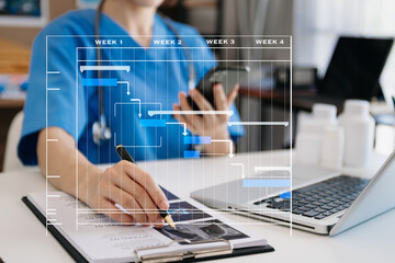 Project manager working and update tasks with Gantt chart scheduling diagram at hospital .success smart medical doctor working with smart medical doctor concept..