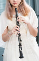 Portrait of Young Female Musician Playing Clarinet. Rehearsal before performing on stage.