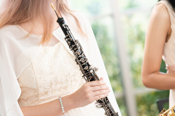 Portrait of Young Female Musician Playing Clarinet. Rehearsal before performing on stage.