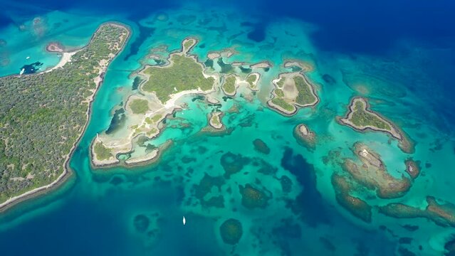 Aerial drone video of exotic paradise volcanic island complex forming a blue lagoon archipelago and featuring sandy beaches in tropical destination
