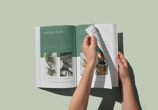Hand Turning a Page of an A4 Magazine Mockup With Custom Colors