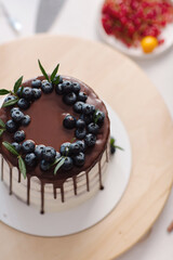 On the table is a delicious beautiful cake with berries for sale. High quality photo