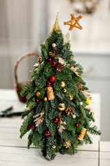 A small Christmas tree stands in the office for a festive mood. High quality photo