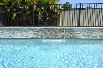 Obraz na płótnie Canvas Swimming pool with fountain and palms