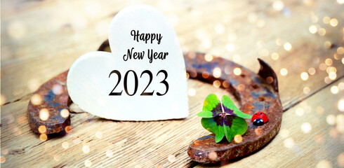 Happy New Year 2023 greeting card - Horseshoe with lucky clover	- Good Luck wishes 
