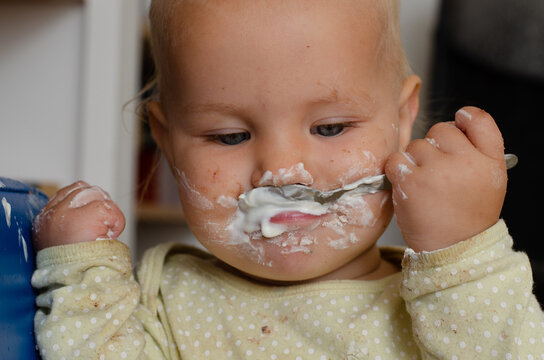 messy baby eats yogurt