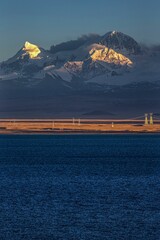 Vertical shot of the Pekucuo lake and Shishapangma snowy mountains during a sunset in Xigaze, China