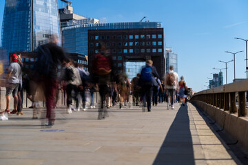 Image of office workers crossing the London bridge in the early morning on the way to the City of London, the leading business and financial area in Europe. Rush hours