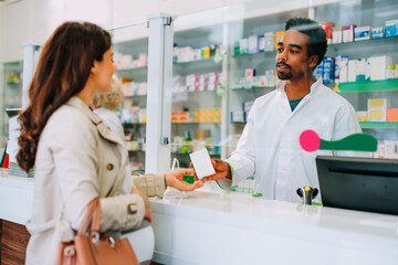 Pharmacist selling medication to customer.