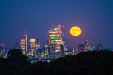 Fototapeta premium Full Moon Rise Over London Skyline London, England, United Kingdom, Europe