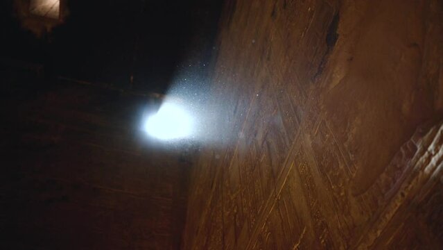 ancient hieroglyphs carving in Egypt pyramids with dust particles moving in the air in slow motion ancient civilisation North Africa Nilo river desert 