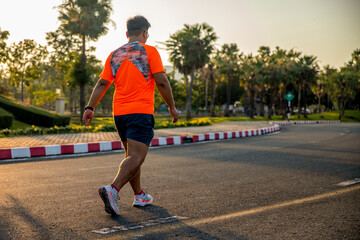 Fototapeta premium Sport man exercise walking on sunset in park for fitness healthy lifestyle.
