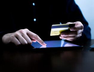 Closeup hand woman using tablet or laptop shopping online,e-business concept.