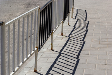 Handrail by road. Pedestrian barrier. Fence along road. Fencing details