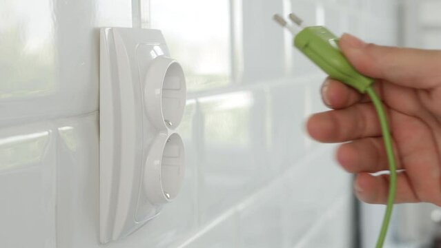Unplugging Electrical Cord in Wall European Socket, Unplug in Devices, Electric Power View, Save Cost in Energy Industry Crisis