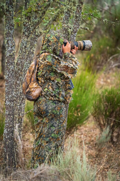Photographer dressed in camouflage suit taking pictures