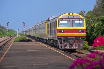 Obraz premium Passenger train by diesel locomotive on the railway.
