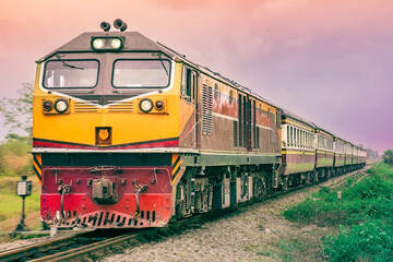 Fototapeta premium Passenger train by diesel locomotive on the railway.