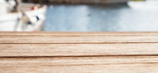 empty wooden table and sea in background