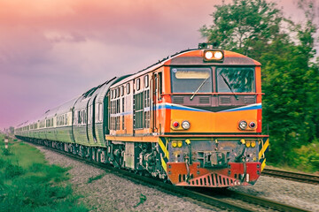 Obraz premium Passenger train by diesel locomotive on the railway.
