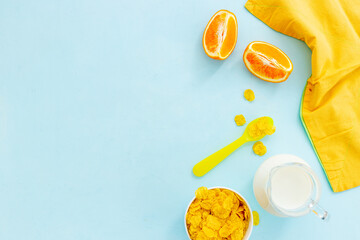 Children breakfast with snack - cereals with oranges, top view