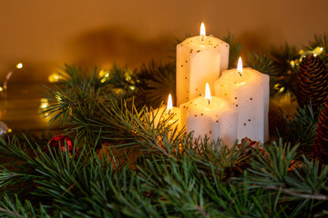  Christmas and New Year candles and ornaments over dark background with lights. Advent - Four purple candles with Christmas ornament . Romantic Christmas night with candlelight and bokeh background.