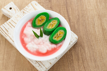 Es Pisang Ijo, traditional dessert from Makassar, South Sulawesi, Indonesia, made from banana which is rolled with a mixture of wheat flour, rice flour and coconut milk. Served with pureed and syrup.
